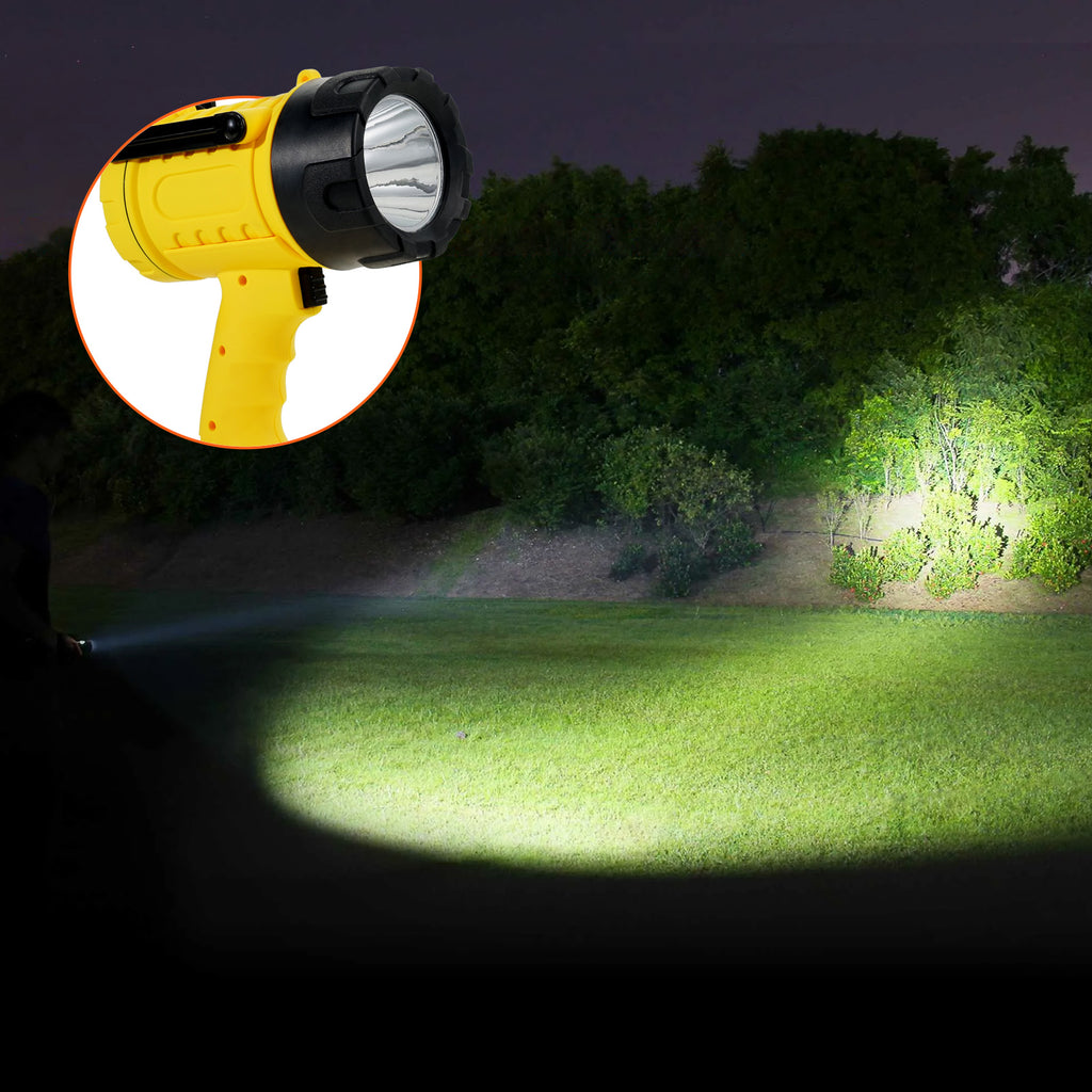 VEVOR handheld spotlight spotlight throwing a long white beam across a field at night