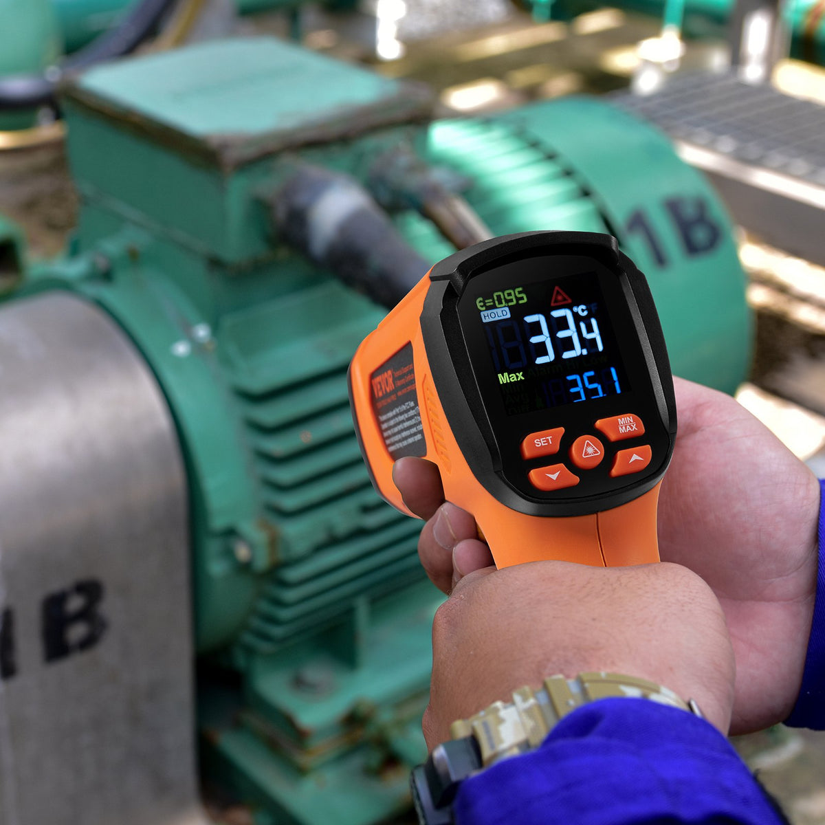 VEVOR infrared thermometer being aimed at an industrial electric motor